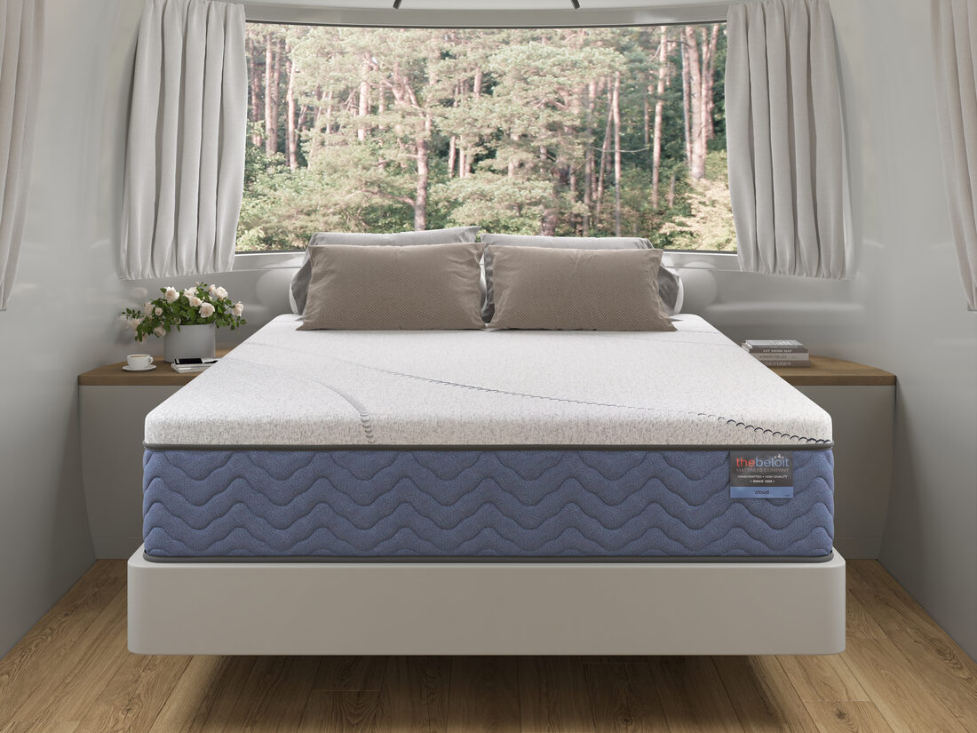 A Beloit mattress in an Airstream by a forest window